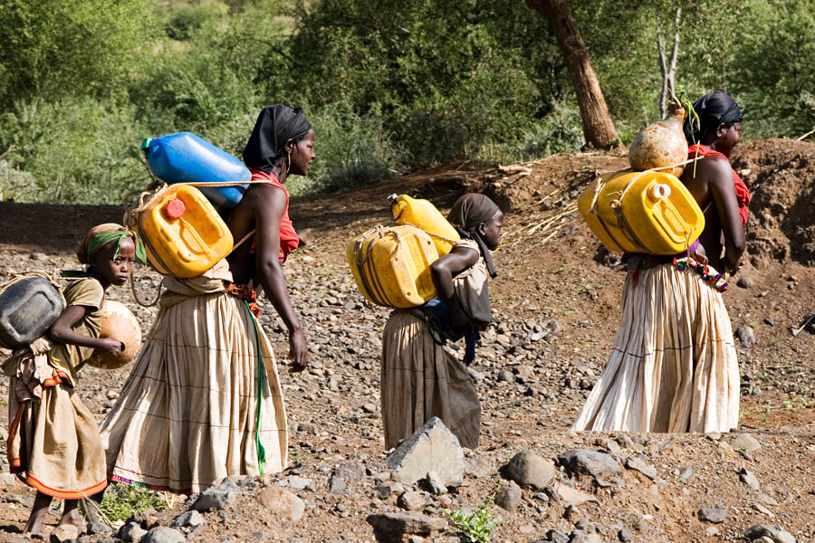 196   Konso girls on there way to the waterwell   there daily heavy job
